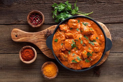 Flavor of India butter chicken dish and side dishes