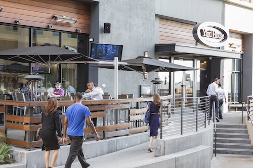 Outside of Yard House restaurant showing patio and people walking