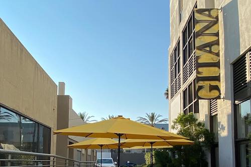 Gitana sign with yellow umbrellas and blue sky