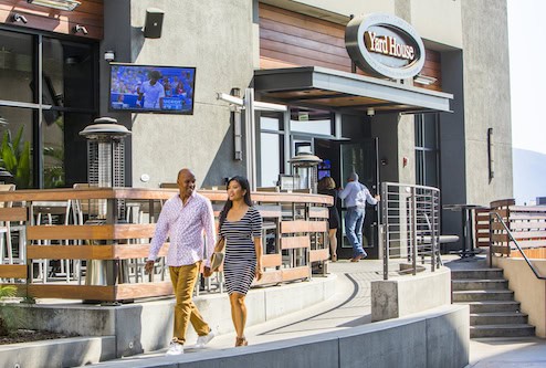 Outside of Yard House restaurant showing a couple walking away