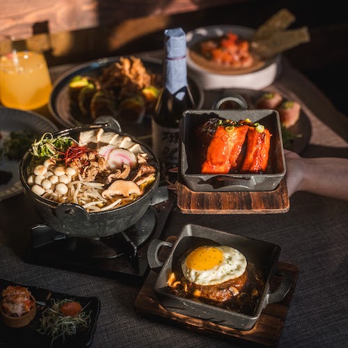 Kopan ramen table top with bowl of ramen and japanese dishes