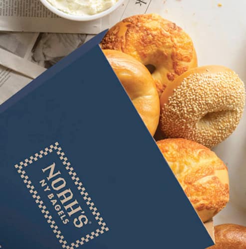 Blue Noah Bagel's bag with bagels coming out the top