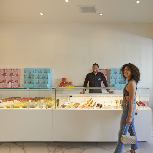 Woman standing in front of pastry counter