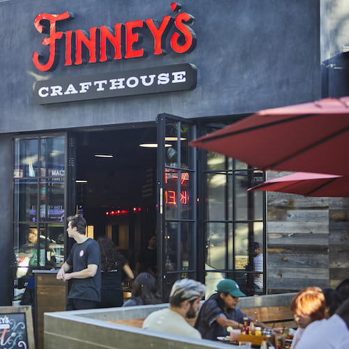 Finney's Crafthouse front entrance with red umbrellas