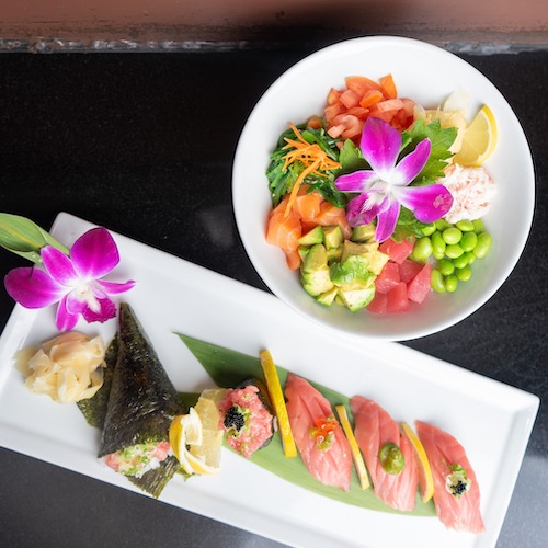 Sushi plates on black table