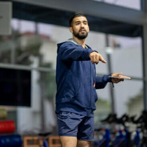 Trainer standing up and pointing at F45 Training Gym