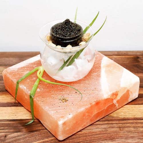 Papa's meat & seafood caviar in a bowl on top of a pink salt block