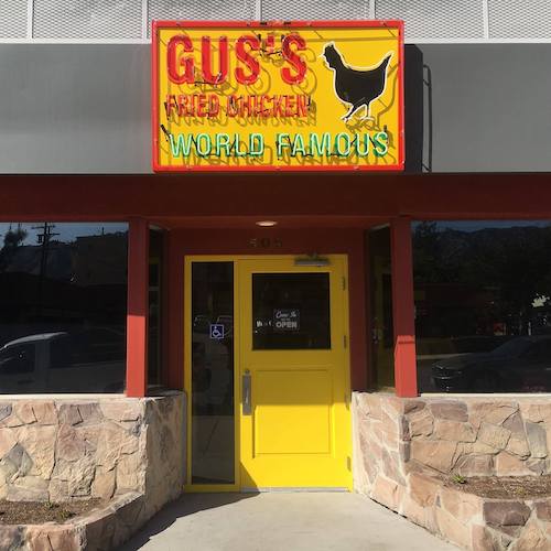 Gus's World Famous Fried Chicken sign and yellow front door