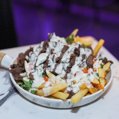 French fries topped with meat and white sauce