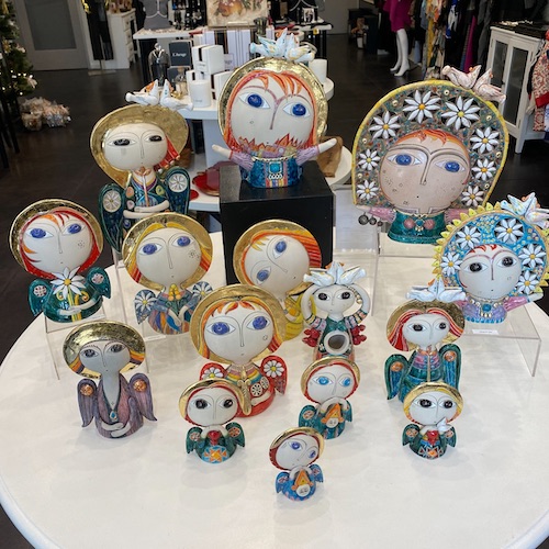 Artistic dolls with round faces displayed on a white table