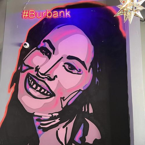 Kalaveras mural of woman with black hair and pink skin