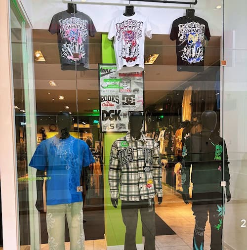 Window display of Gear Locker showing black mannequins wearing street style clothing.