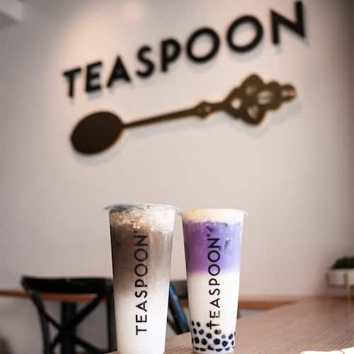 Two teaspoon Boba drinks in front of a Teaspoon sign