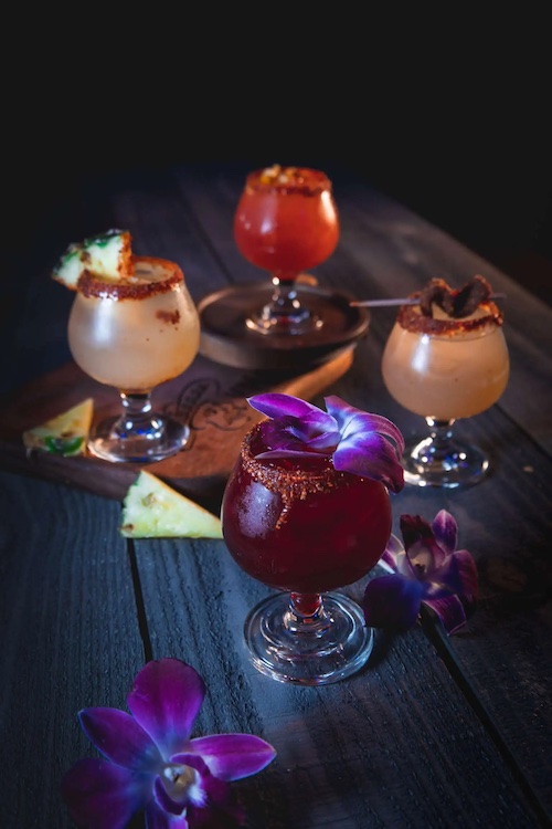 Four cocktails displayed on a table