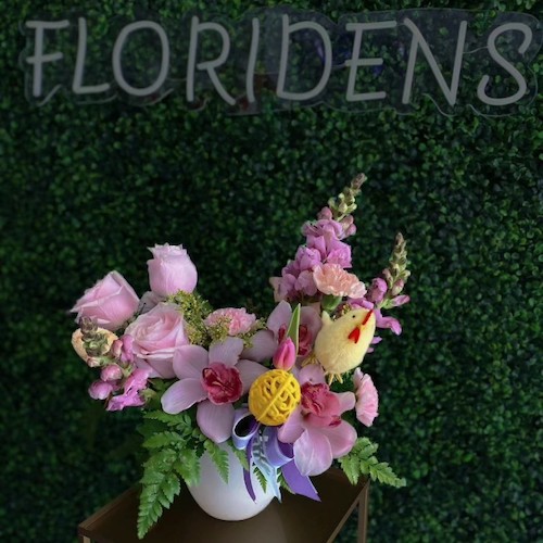 Floridens sign with green background and floral bouquet