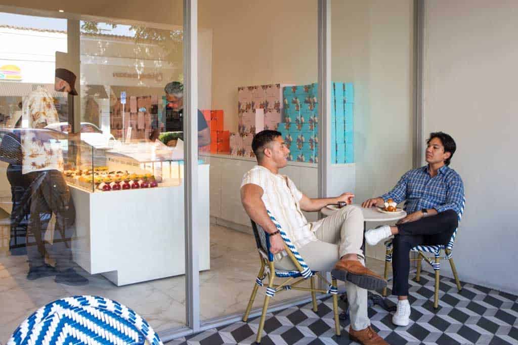 Friends enjoying pastries at an outdoor cafe in Downtown Burbank near Valentine's Day dining spots.